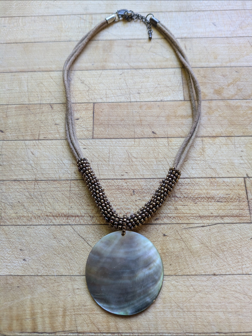 Harvest Moon Brown Beaded Cord Necklace with Iridescent Circular Shell Pendant